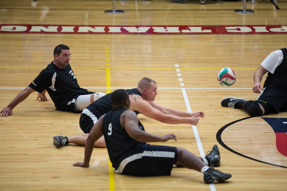 Sgt. Scotty Hastings dives for the ball in sitting volleyball at the 2014 Warrior Games
