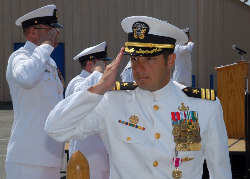 Cmdr. Joseph DiGuardo salutes during the change of command ceremony