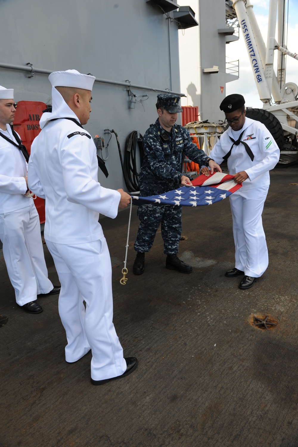 USS Nimit sailors fold ensign