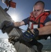 USS Mason sailor secures outrigger