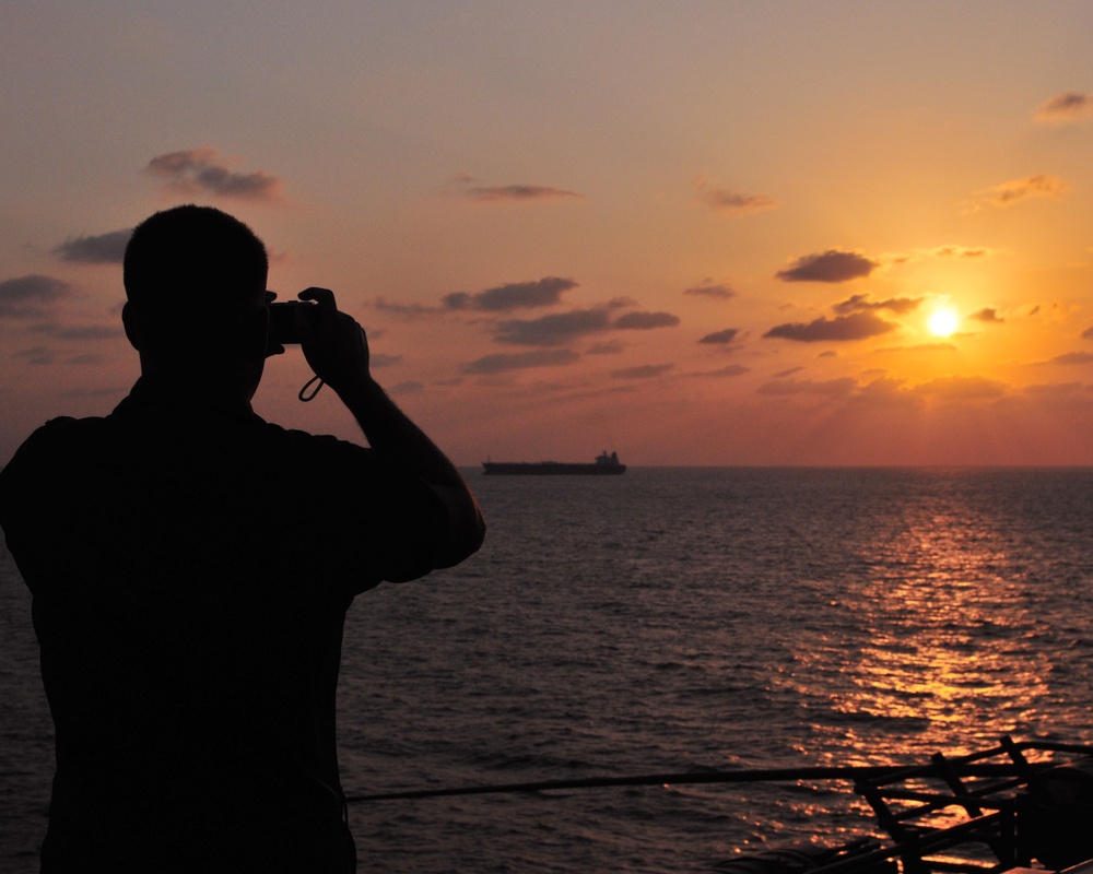 Marine takes photos of sunset aboard USS Bataan