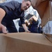 USS Cole sailors move boxes during replenishment