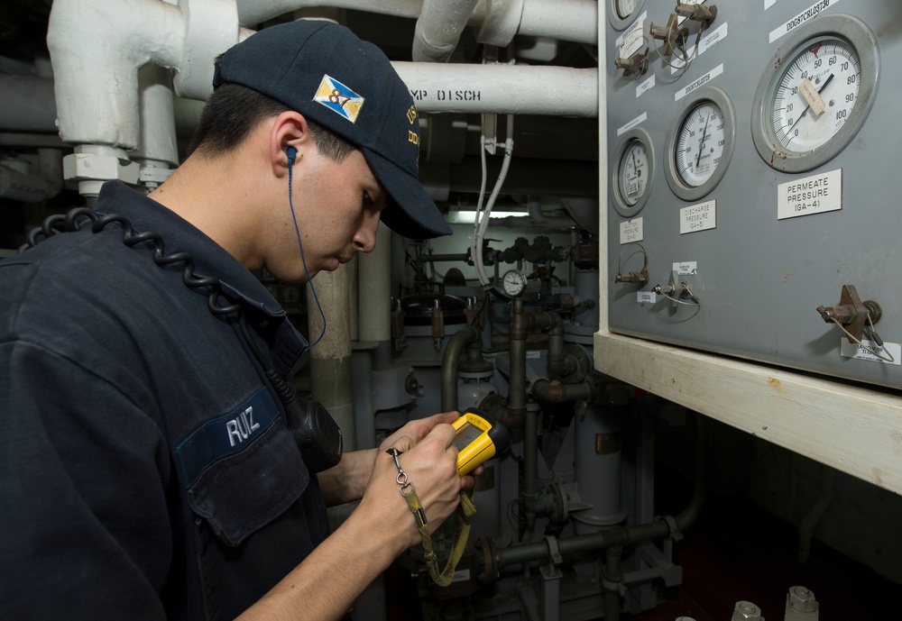 USS Mason sailor collects readings in engine room