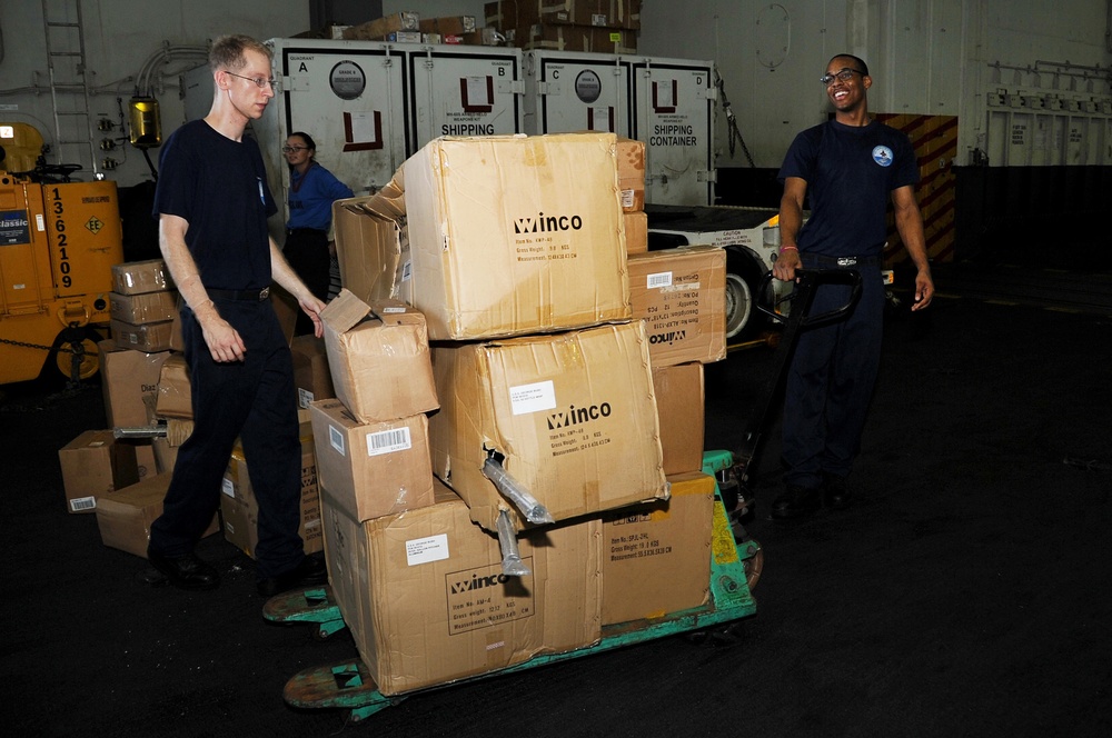 USS George H.W. Bush Sailors move supplies