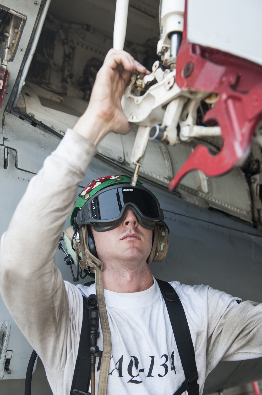 USS George H.W. Bush sailor inspects aircraft