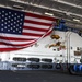 USS Nimitz sailors hang flag before change of command ceremony