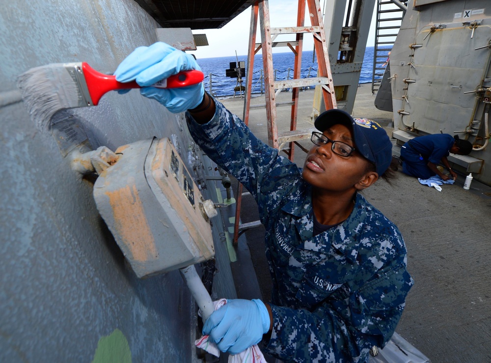 USS Nitze Sailor paints a bulkhead