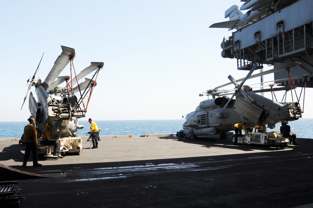 USS George H.W. Bush Sailors move Seahawk helicopters