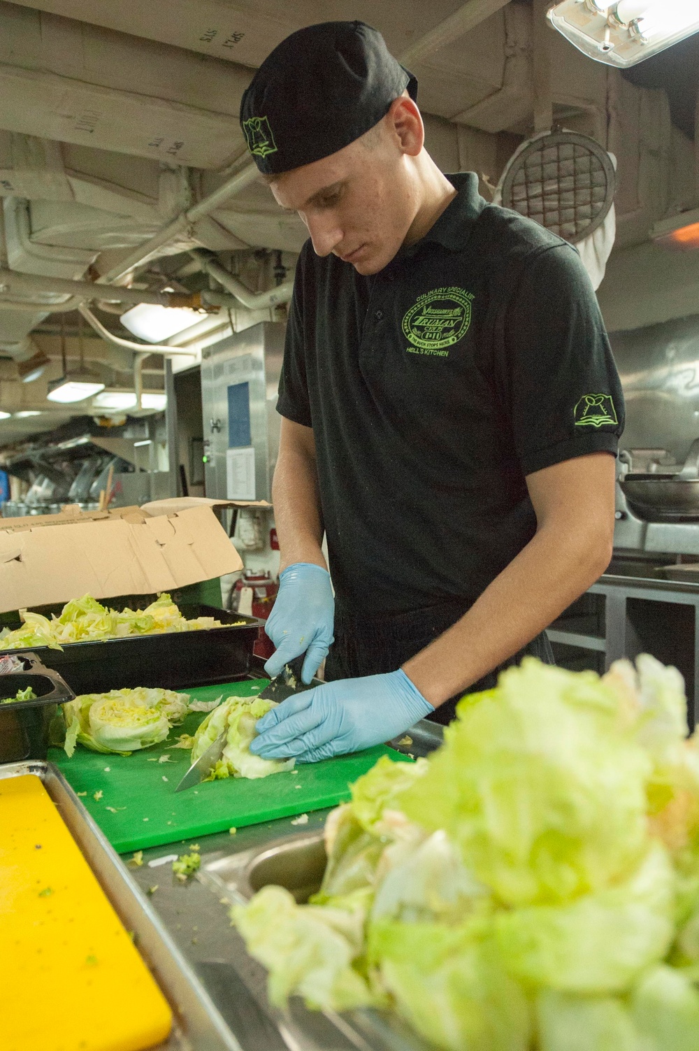 Preparing lettuce in the galley