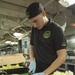 Preparing lettuce in the galley