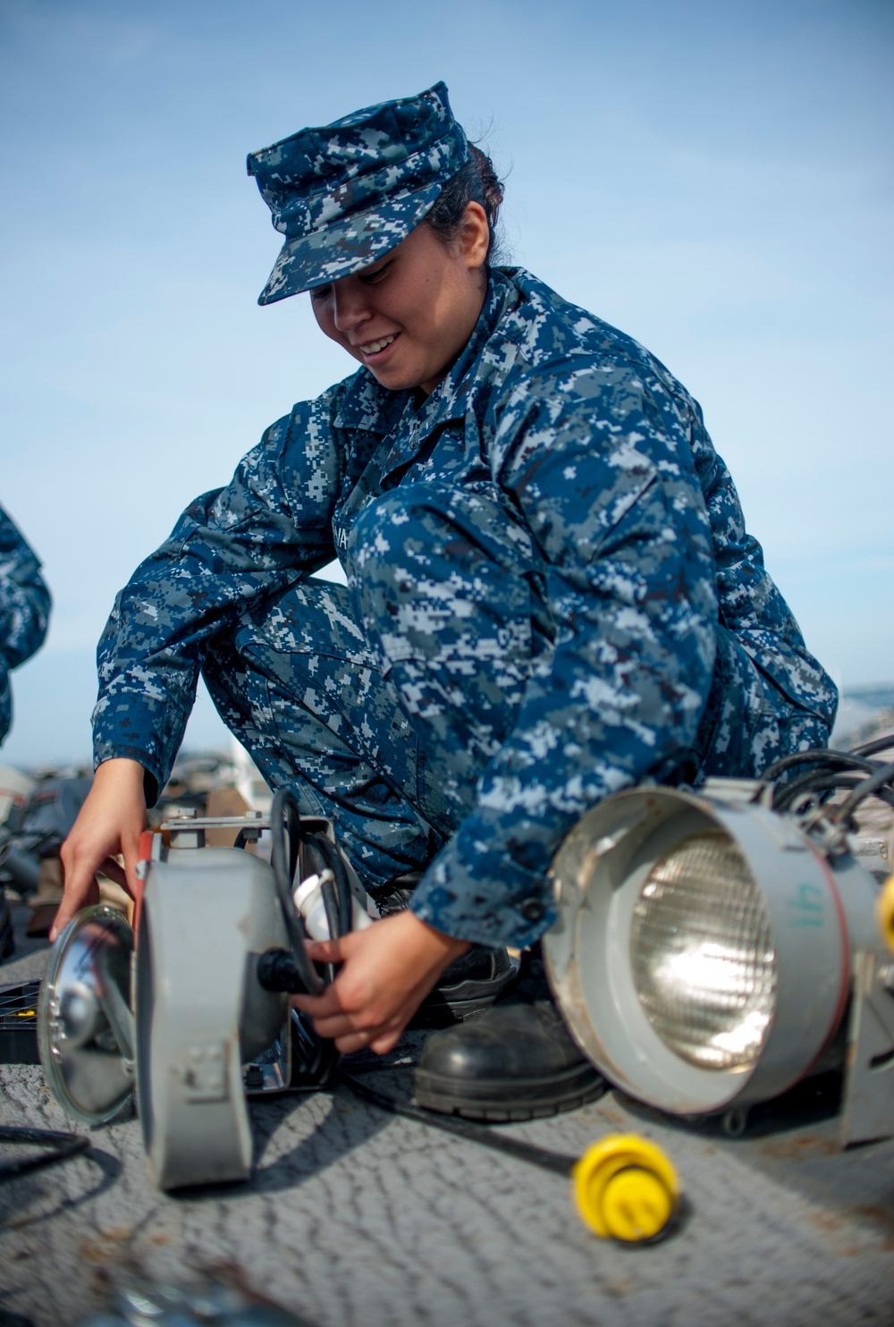 USS Harry S. Truman sailor repairs light