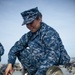 USS Harry S. Truman sailor repairs light