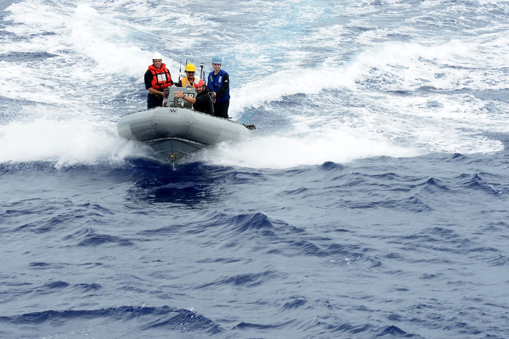 USS Dewey rigid-hull inflatable boat team approaches USS Bunker Hill