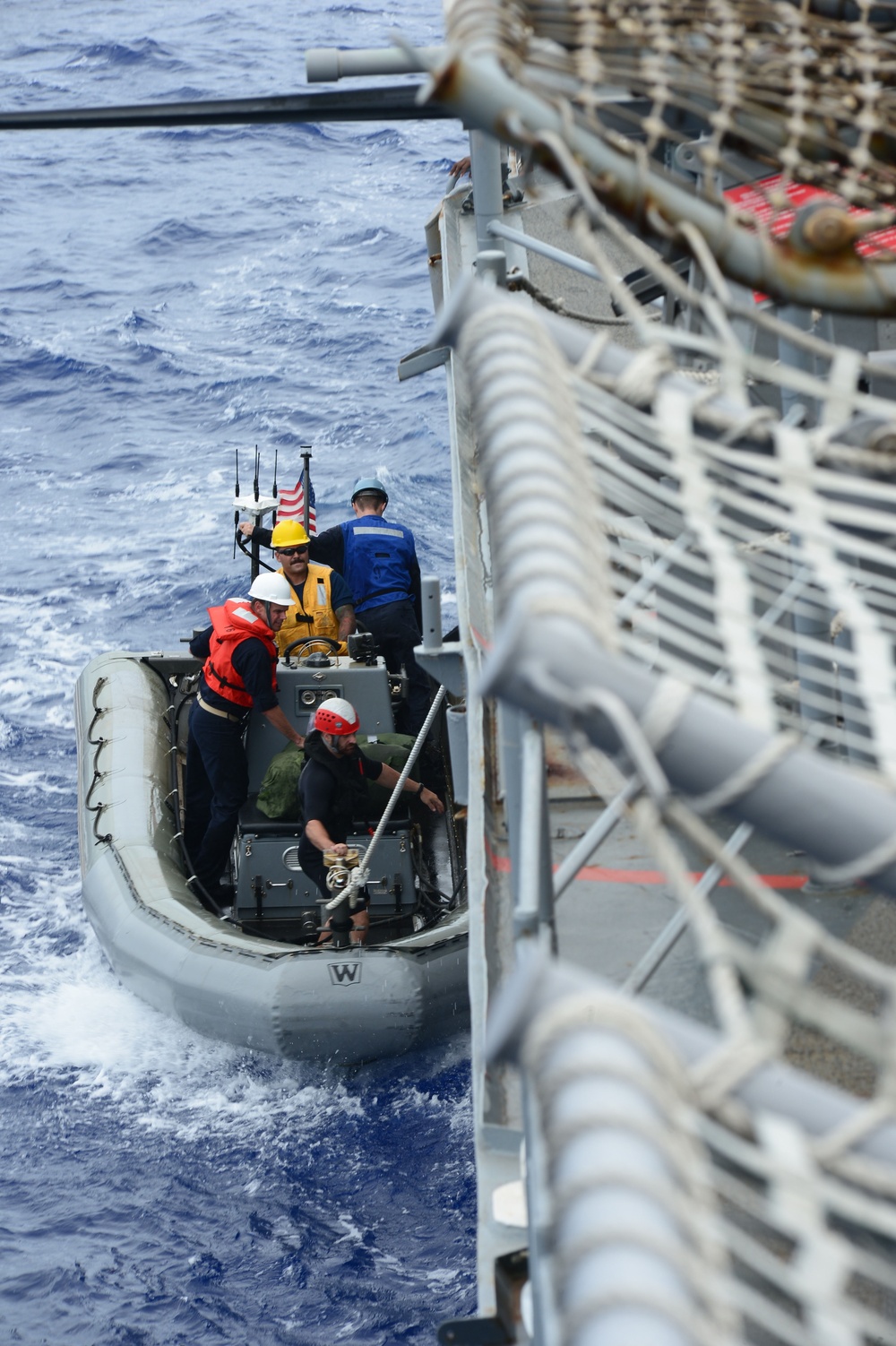 USS Dewey rigid-hull inflatable boat team pulls alongside USS Bunker Hill