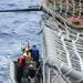 USS Dewey rigid-hull inflatable boat team pulls alongside USS Bunker Hill