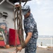 Airman coils line on flight deck