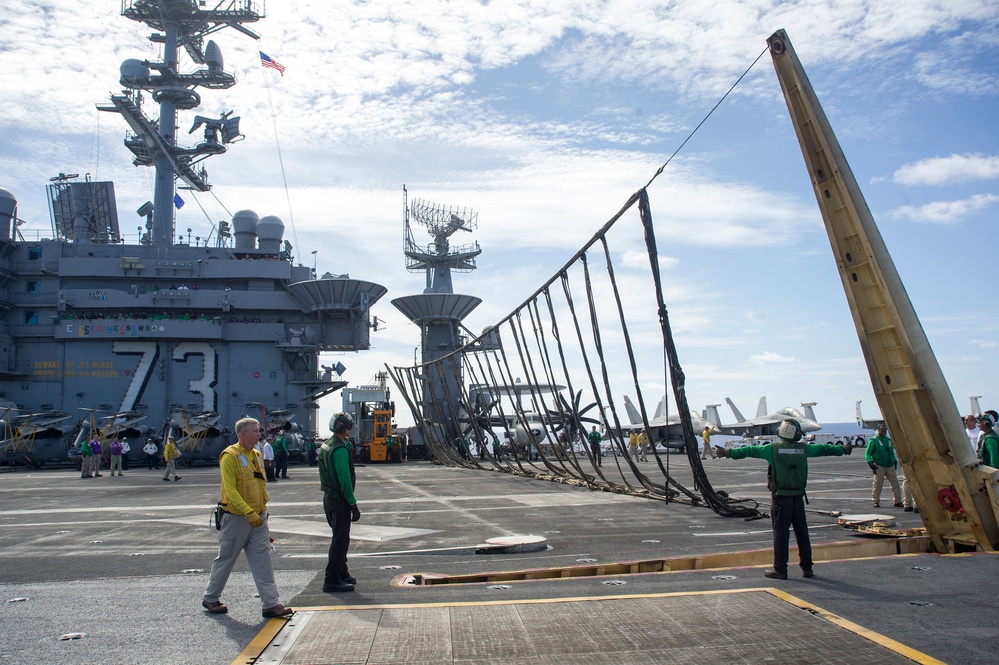 USS George Washington Sailors raise emergency barricade