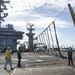 USS George Washington Sailors raise emergency barricade