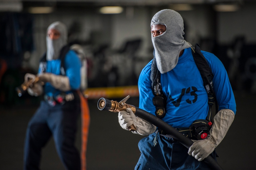 USS Harry S. Truman Sailors fight a simulated aircraft fire