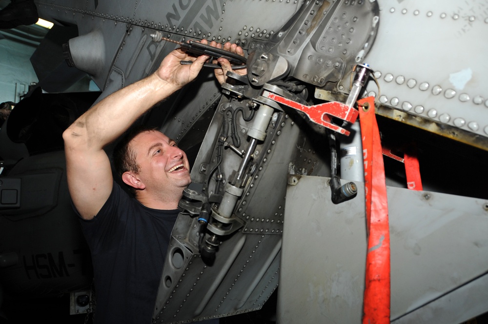 USS George H.W. Bush sailor performs maintenance