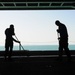 USS George H.W. Bush sailors sweep hangar bay