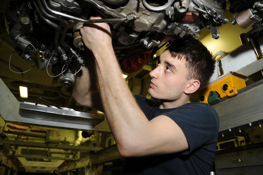 USS George H.W. Bush sailor repairs gear box