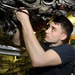 USS George H.W. Bush sailor repairs gear box