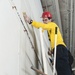 USS George H.W. Bush Sailor cleans a hangar bay door