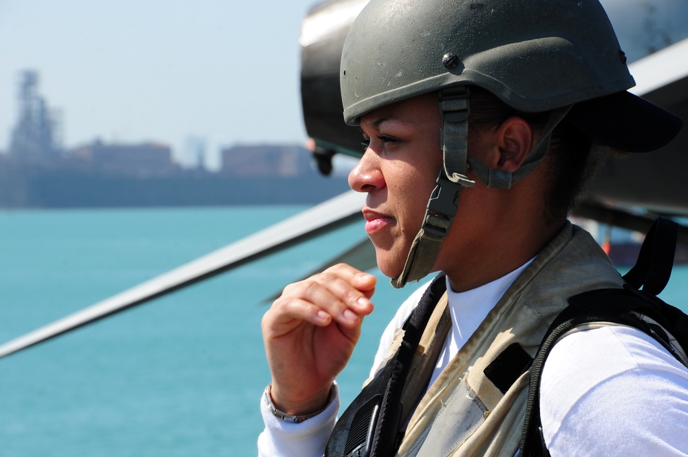 USS George H.W. Bush Sailor stands armed watch on the flight deck