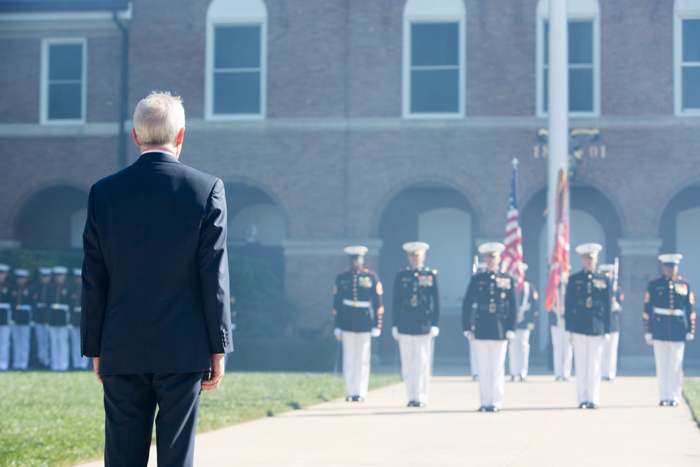 Secretary of the Navy standing after canons smoke clears at 35th Commandants Change of Command Ceremony