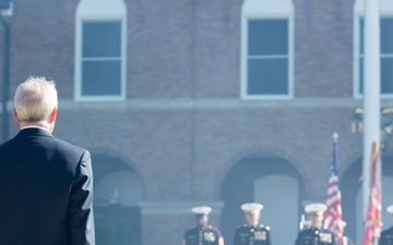 Secretary of the Navy standing after canons smoke clears at 35th Commandants Change of Command Ceremony