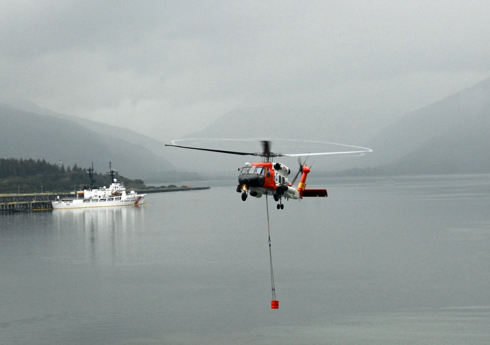 Coast Guard MH-60 Jayhawk helicopter aircrew performs cargo hoist training at Air Station Kodiak, Alaska