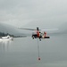 Coast Guard MH-60 Jayhawk helicopter aircrew performs cargo hoist training at Air Station Kodiak, Alaska