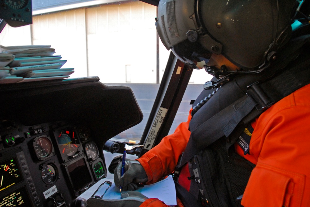 Coast Guard MH-65 Dolphin Helicopter aircrew conducts a training flight over Kodiak, Alaska