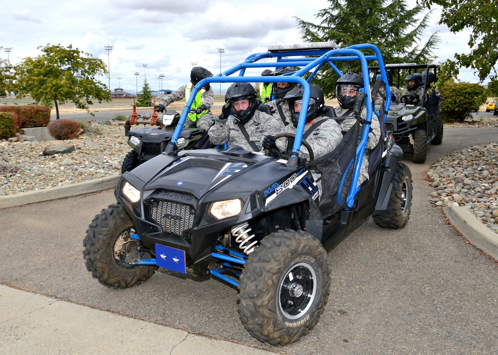 All-terrain vehicle with members from the 9th Security Forces Squadron