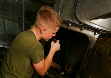 Lance Cpl. Garrett J. Burke fixes the pulper aboard the USS Makin Island