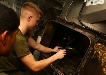 Lance Cpl. Garrett J. Burke fixes the pulper aboard the USS Makin Island