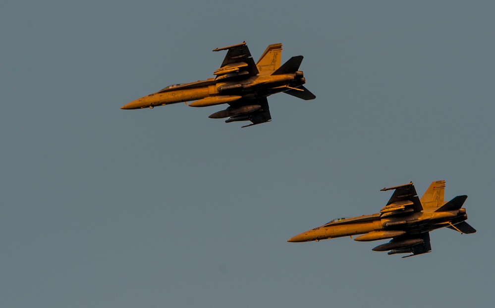 F/A-18C Hornets fly above USS Carl Vinson