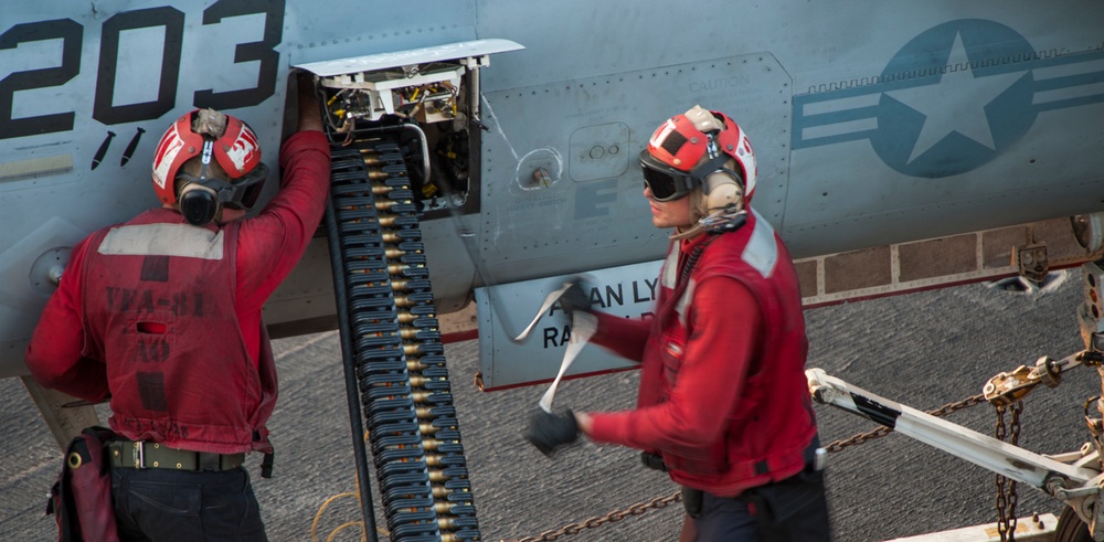 Sailors download rounds from an F/A-18E Super Hornet aboard USS Carl Vinson