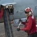 Sailors download rounds from an F/A-18E Super Hornet aboard USS Carl Vinson