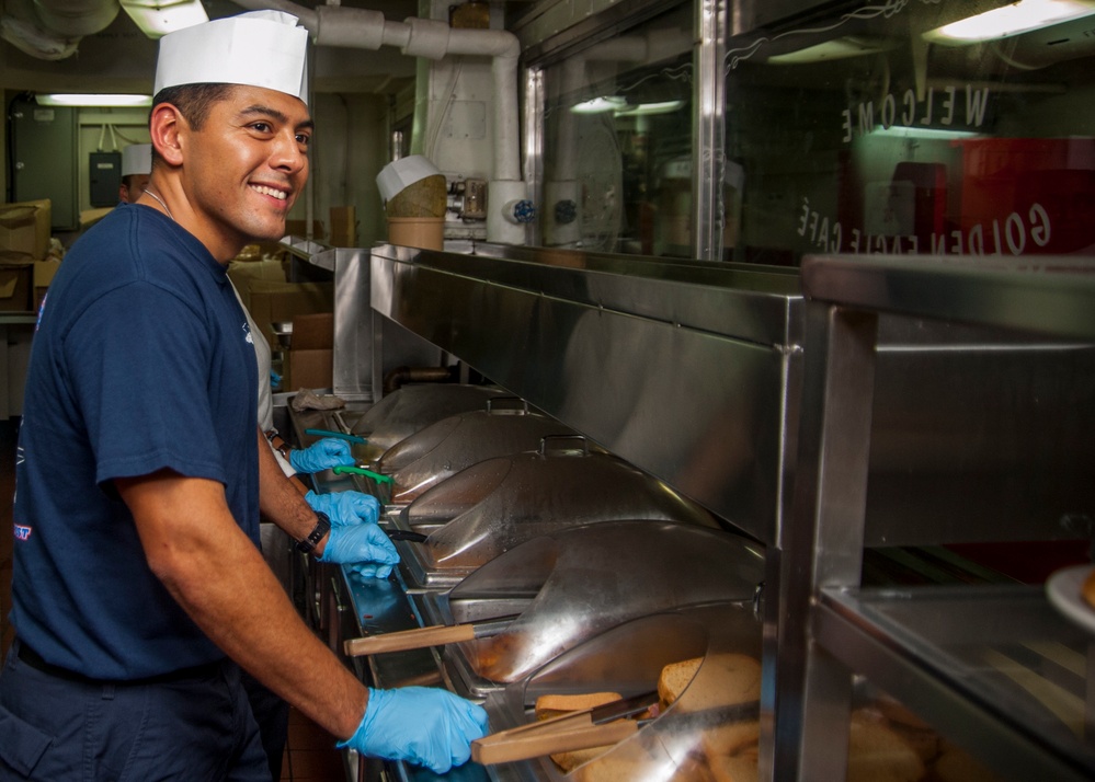 1st Class Petty Officer Association Sailors serve food aboard USS Carl Vinson