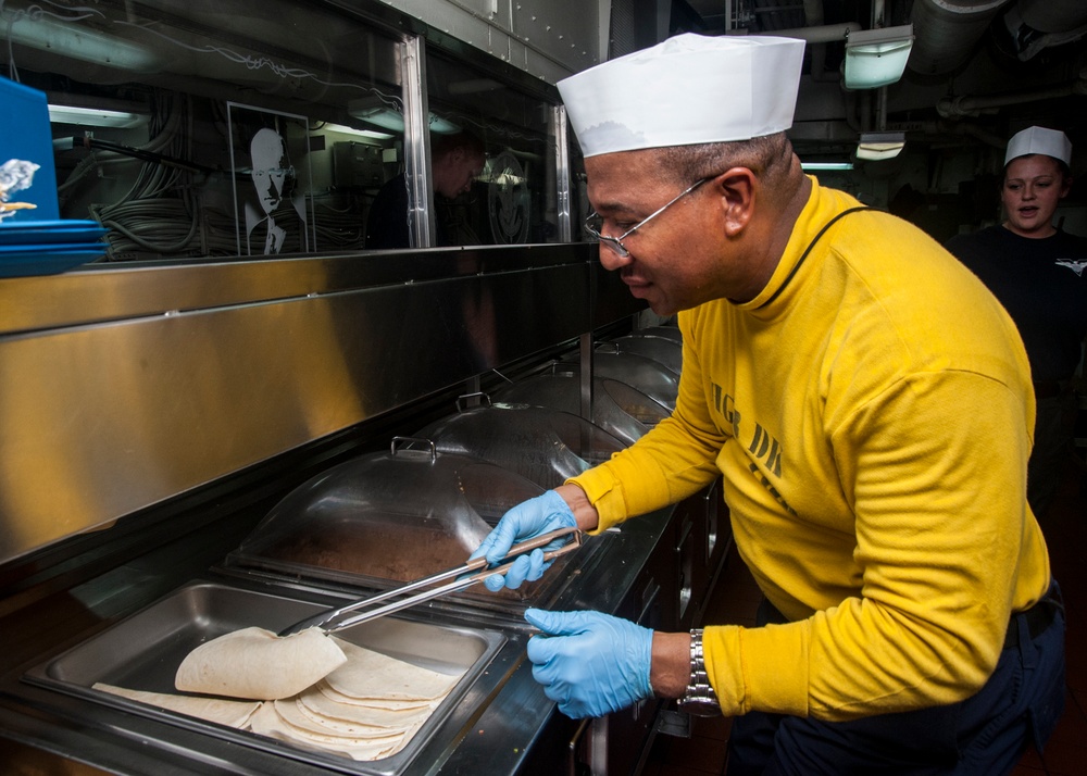 1st Class Petty Officer Association Sailors serve food aboard USS Carl Vinson