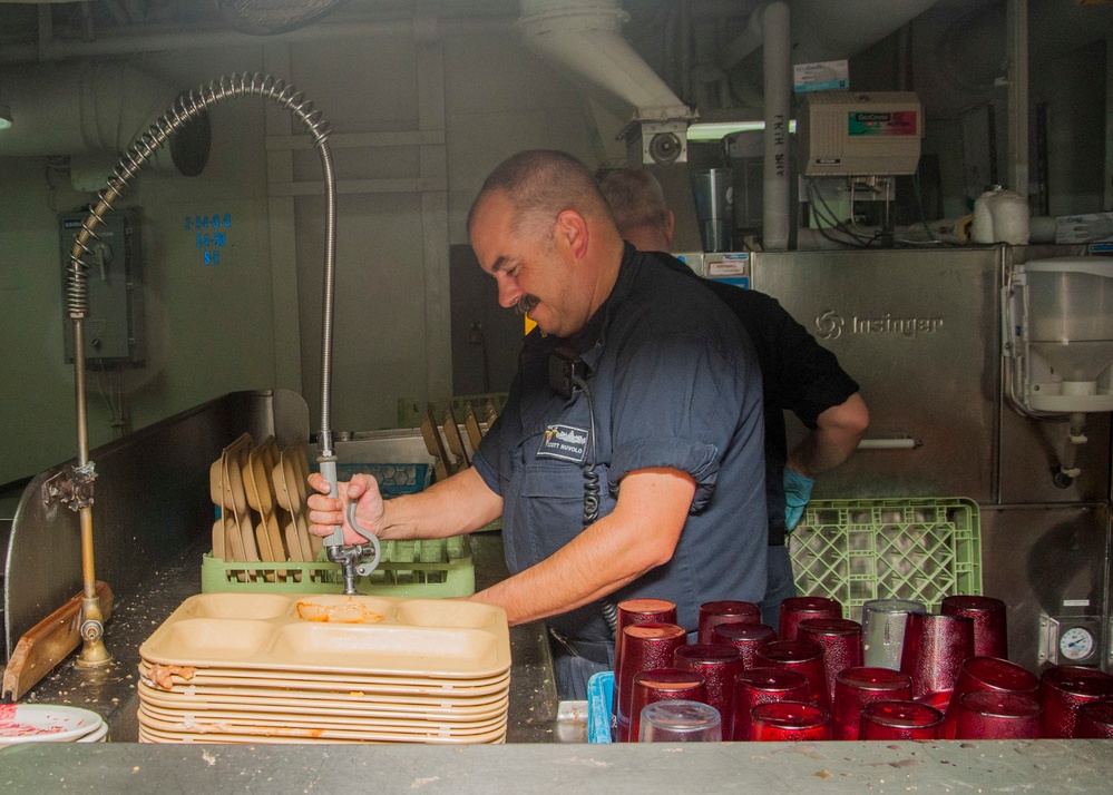 1st Class Petty Officer Association Sailors serve food aboard USS Carl Vinson