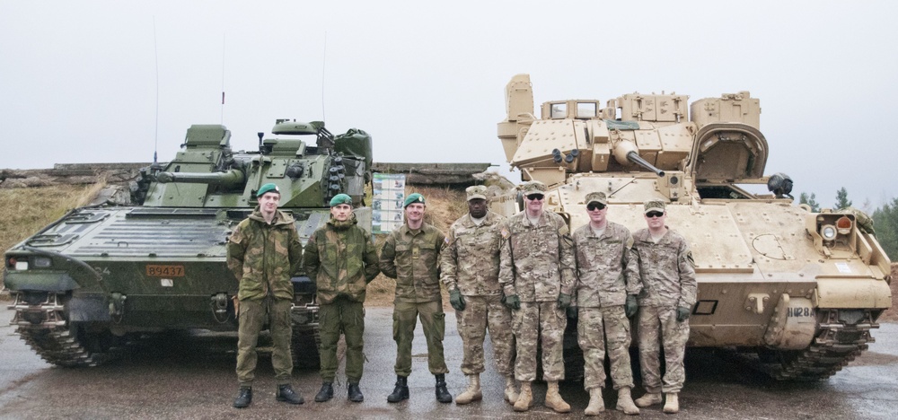Allied light armor crews stand together