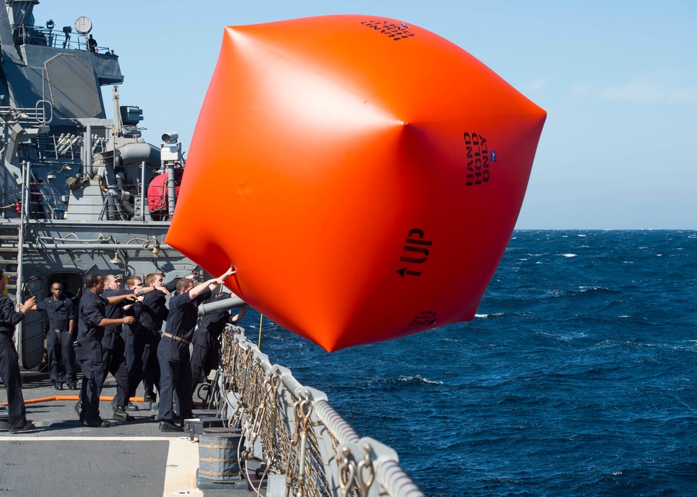 Sailors toss the “Killer Tomato”