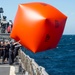 Sailors toss the “Killer Tomato”