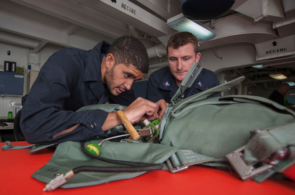 USS Carl Vinson Sailors conduct parachute maintenance