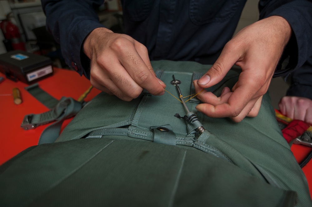 USS Carl Vinson Sailors conduct parachute maintenance