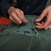 USS Carl Vinson Sailors conduct parachute maintenance