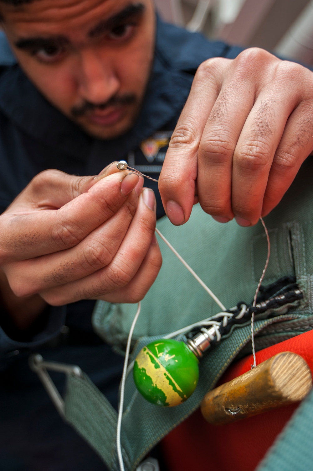 USS Carl Vinson Sailors conduct parachute maintenance